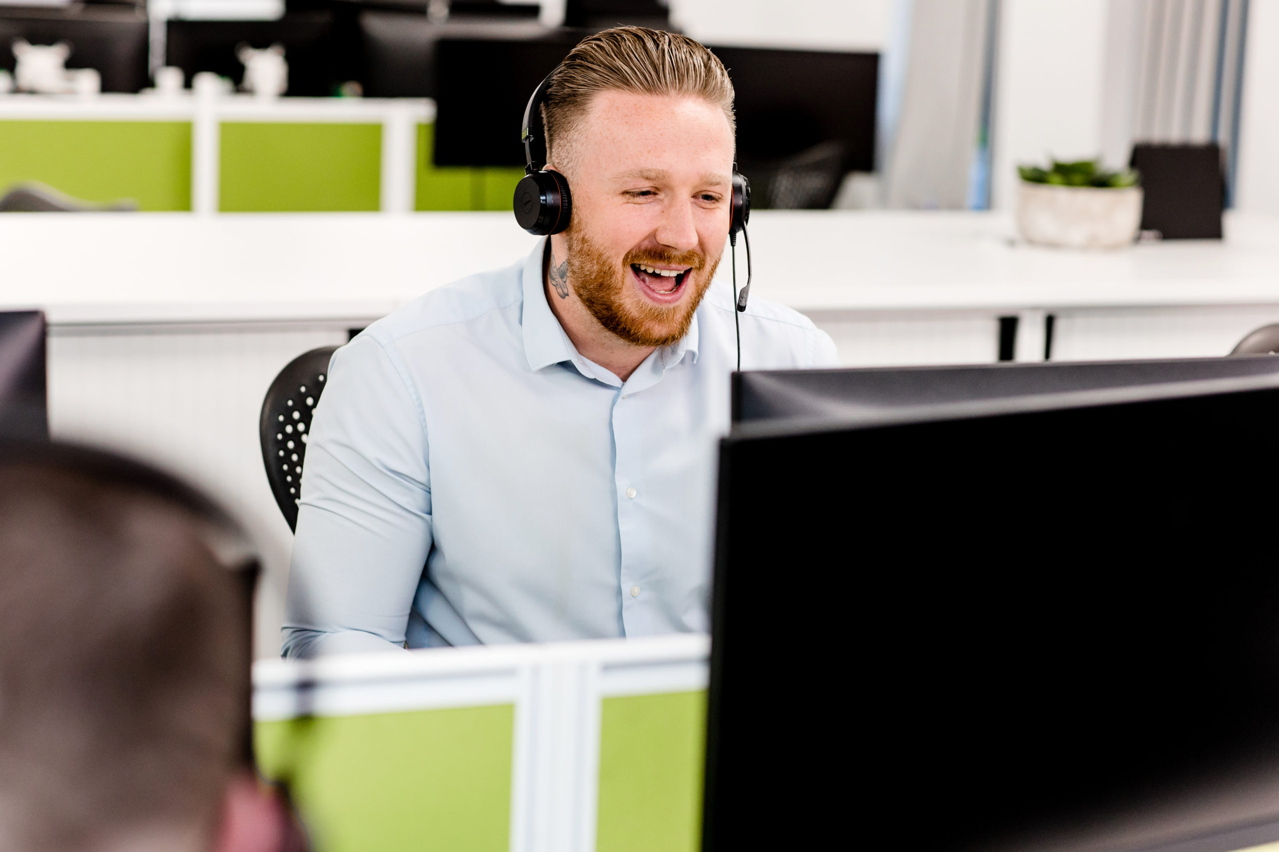an aerial direct staff member using a headset to talk to customers