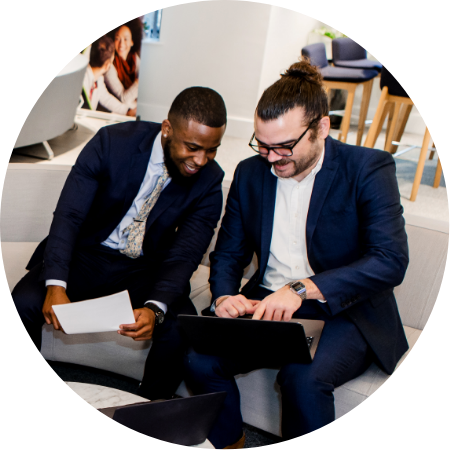 two aerial direct staff using a laptop