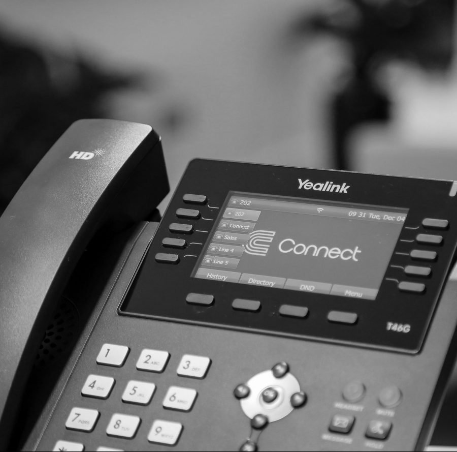 a yealink desk phone featuring the connect logo on the screen